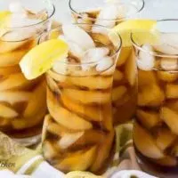 Four glasses of iced tea with lemon.