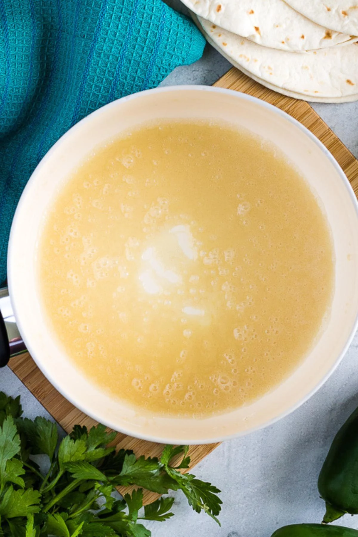 The flour and oil cooking in a medium sized saucepan.