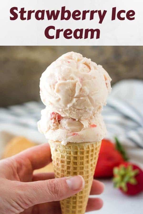 Two scoops of strawberry ice cream served in a waffle cone.