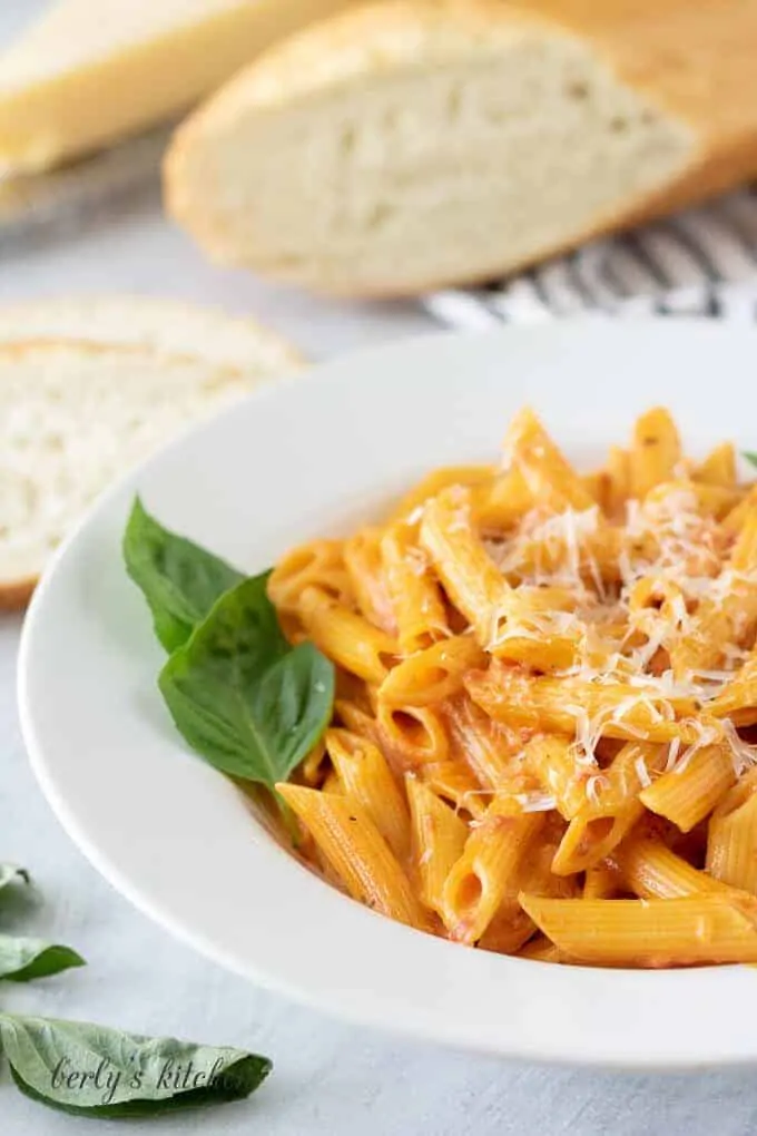 A close-up of the pasta garnished with basil and Parmesan.