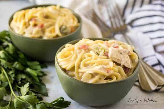 Two decorative bowls of the creamy instant pot chicken spaghetti.