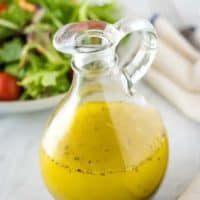 A glass cruet filled with the finished homemade Italian dressing.