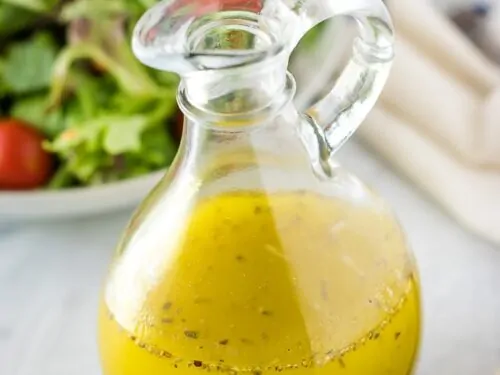 A glass cruet filled with the finished homemade italian dressing.