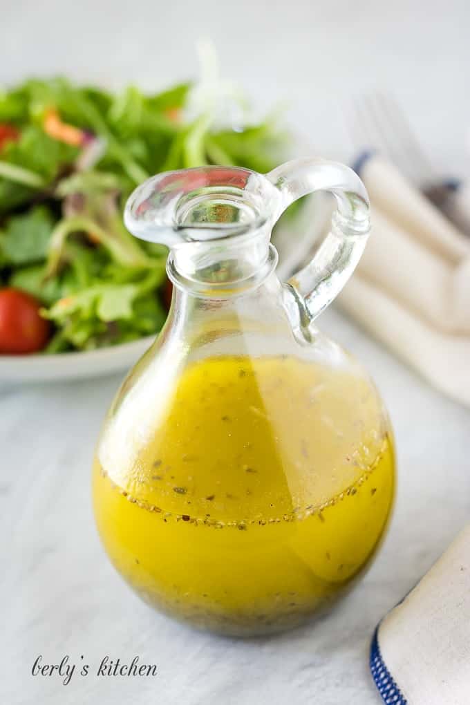 A glass cruet filled with the finished homemade italian dressing.