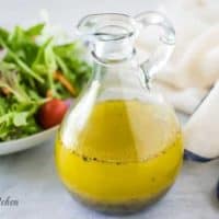 The homemade salad dressing recipe served in a glass cruet.
