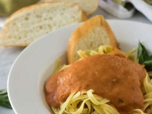 The finished marinara sauce poured over a bowl of pasta.