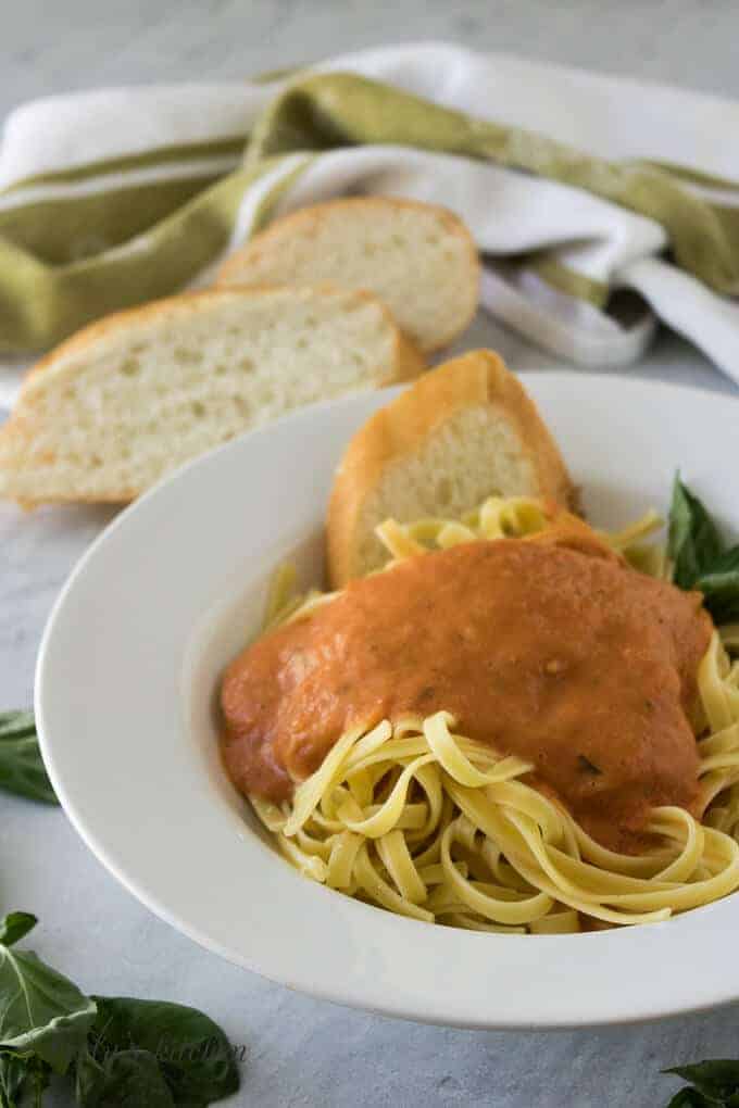 The finished marinara sauce poured over a bowl of pasta.