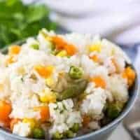 The pressure cooker rice served in a decorative blue bowl.