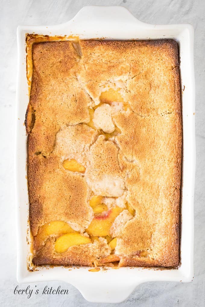 The peach cobbler has baked and the crust has risen.