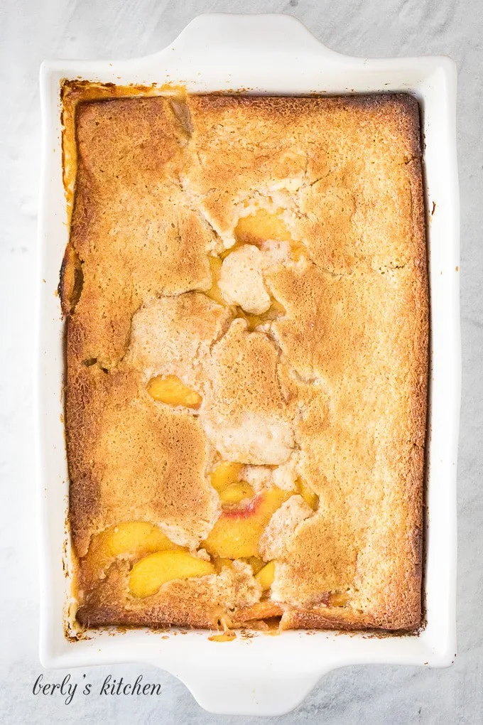 The peach cobbler has baked and the crust has risen.