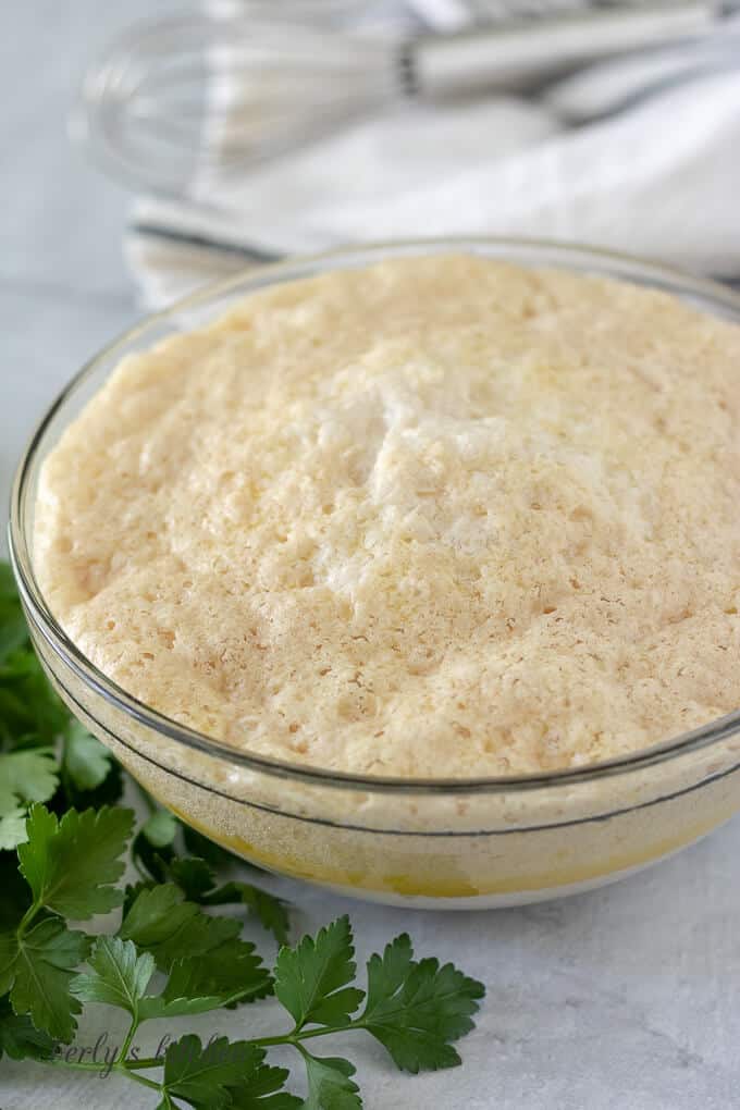 The milk, yeast, and sugar mixture in a small bowl.