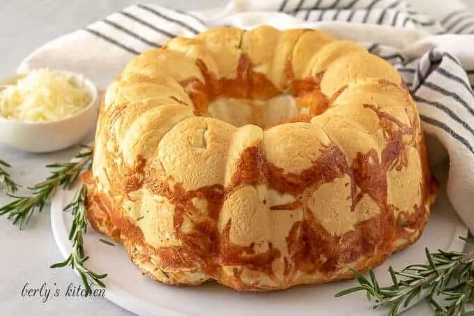 The Parmesan and rosemary pull apart bread on a platter.