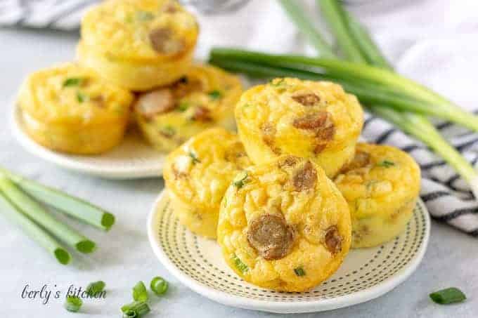 Eight of the sausage egg and cheese muffin cups on a plate.