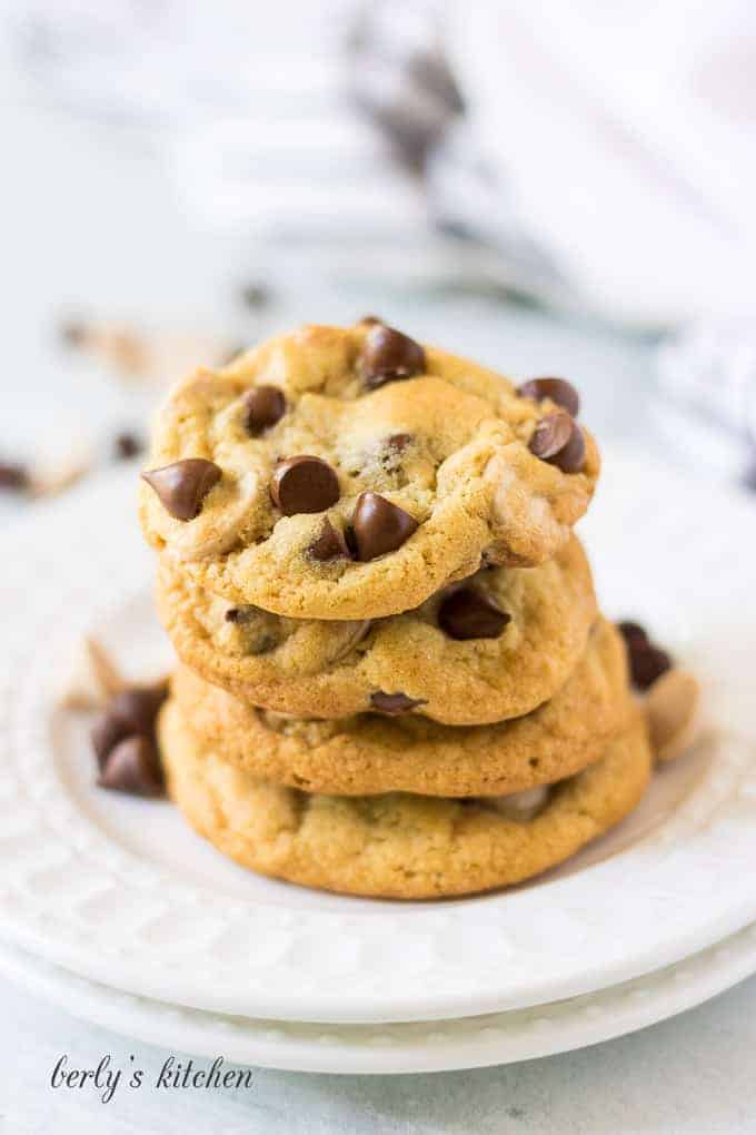 A small stack of four caramel chocolate chip cookies.