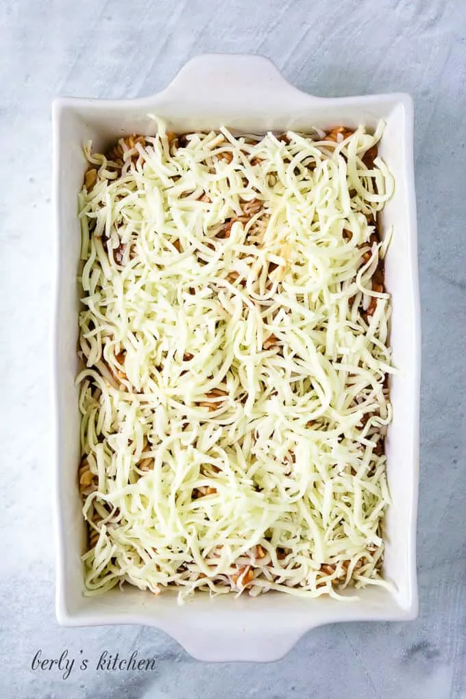 Everything has been transferred to a baking dish and covered with cheese.