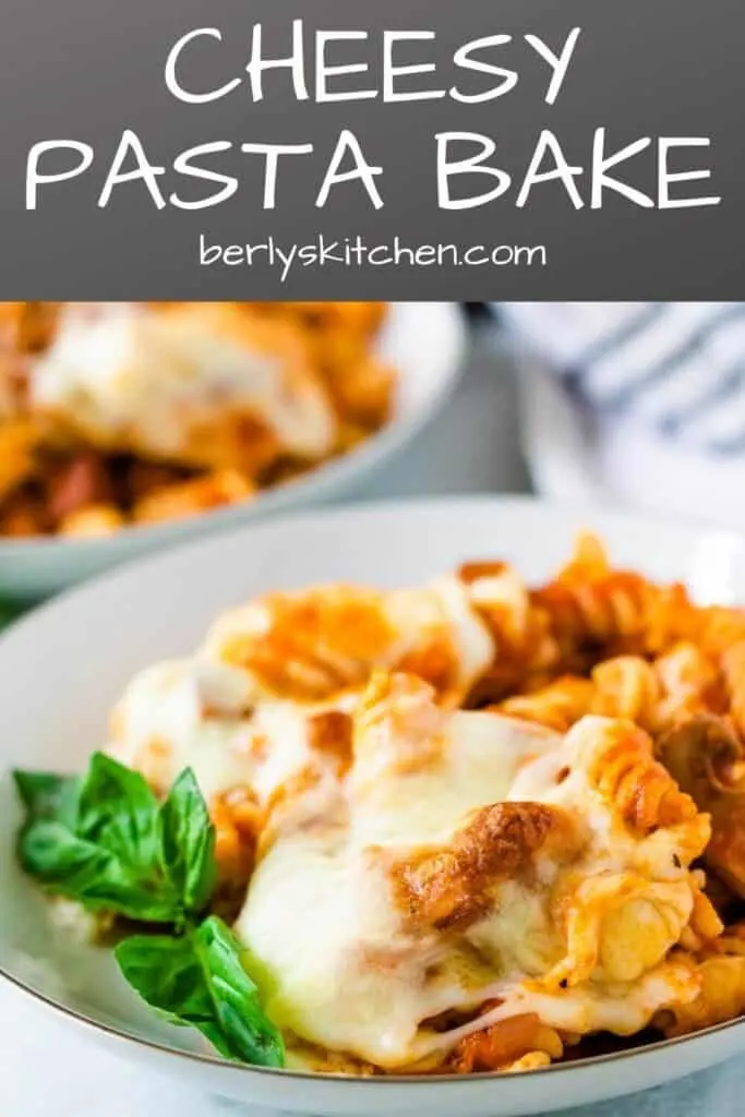 The cheesy pasta bake casserole serve in white bowls with fresh basil.
