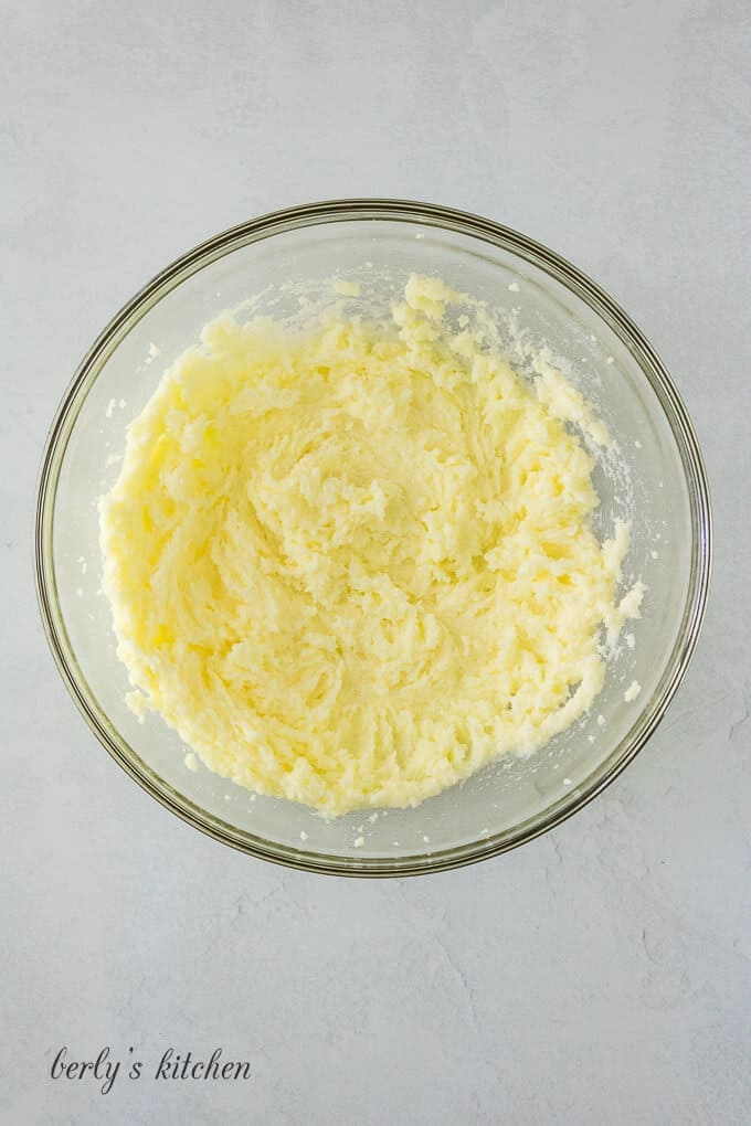 Butter, salt, and sugar whipped in a glass mixing bowl.