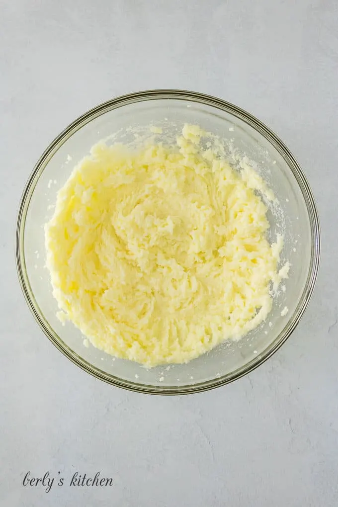 Butter, salt, and sugar whipped in a glass mixing bowl.