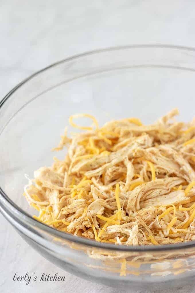 Shredded cheese has been combined with the meat and spices.