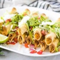 The baked chicken taquitos with lettuce, tomatoes, and sour cream.