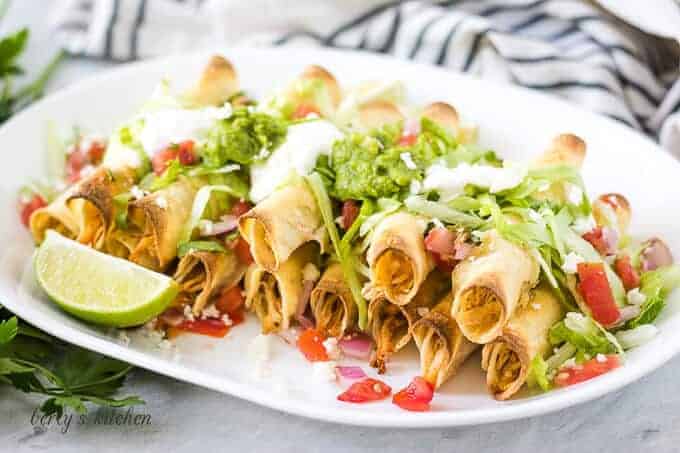 The baked chicken taquitos with lettuce, tomatoes, and sour cream.