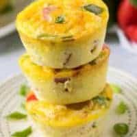 Three stacked egg muffins sitting on a small decorative plate.