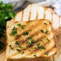 Two pieces of grilled texas toast with garlic herb butter.