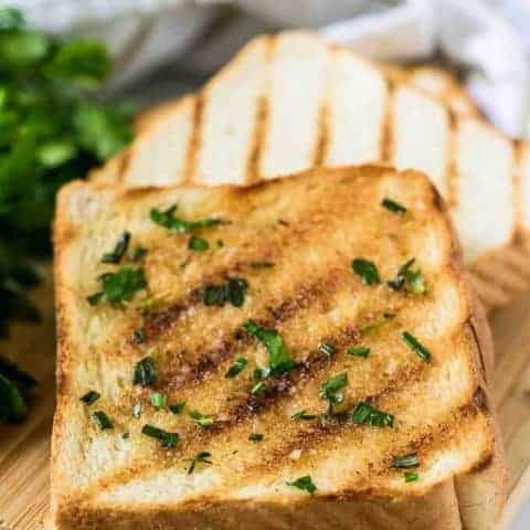 Garlic Herb Butter Recipe Two pieces of grilled texas toast with garlic herb butter.