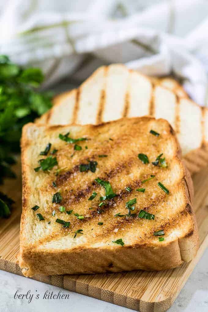 Two pieces of grilled texas toast with garlic herb butter.