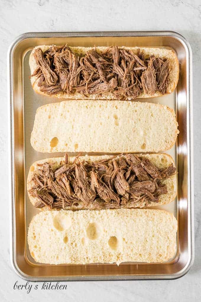 The meat has been shredded and place on French bread.