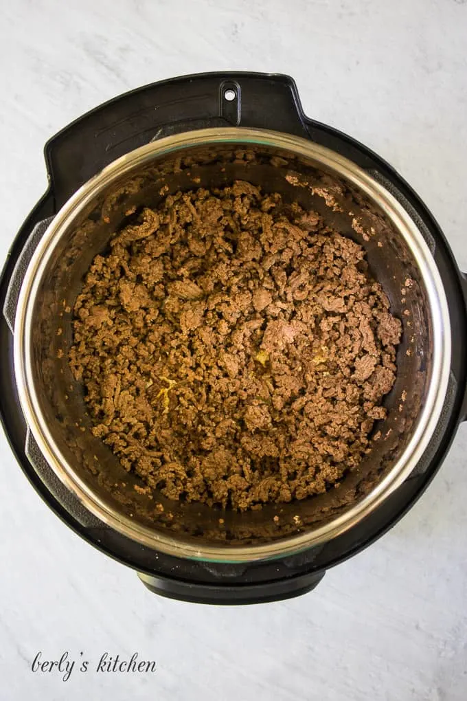 Lean ground beef and spices cooking in the pressure cooker.