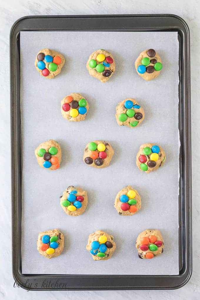 The cookie balls have been placed on a sheet pan.