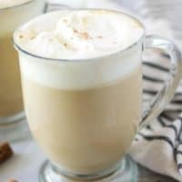 The coffee drink has been garnished with whipped cream and ground cinnamon.