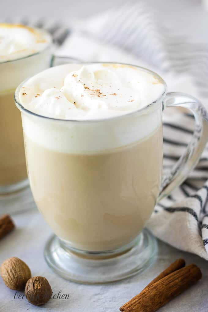 Instant pot pumpkin spice latte garnished with whipped cream and ground cinnamon.