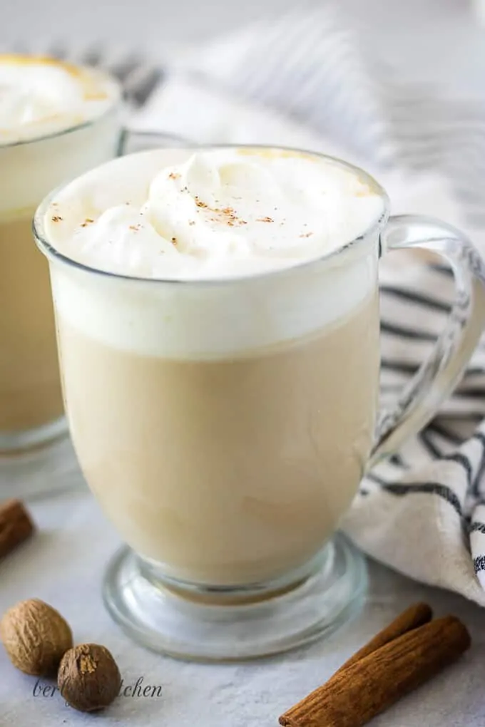 The coffee drink has been garnished with whipped cream and ground cinnamon.
