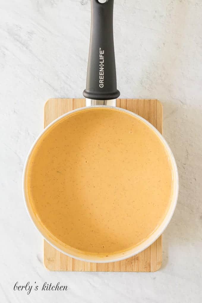 The chipotle cream sauce sitting in a large saute pan.