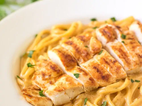 A close up view of the spicy chicken pasta in a large bowl.