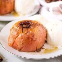 One baked apple served with a scoop of ice cream.