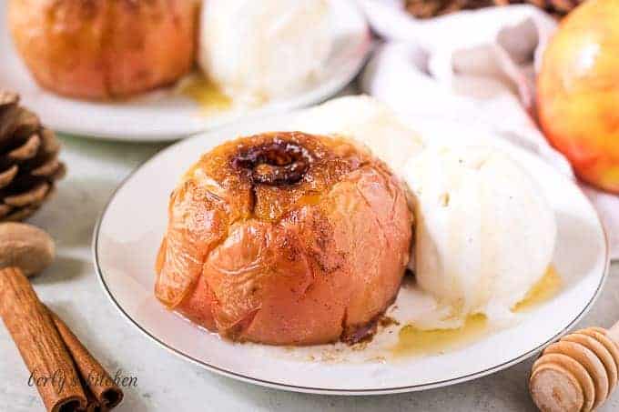 One baked apple served with a scoop of ice cream.