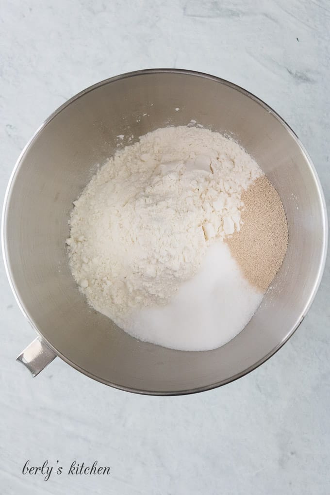 Flour, yeast, and other ingredients in a large mixing bowl.