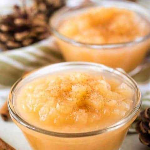 Two small ramekins of Instant Pot applesauce with ground cinnamon.