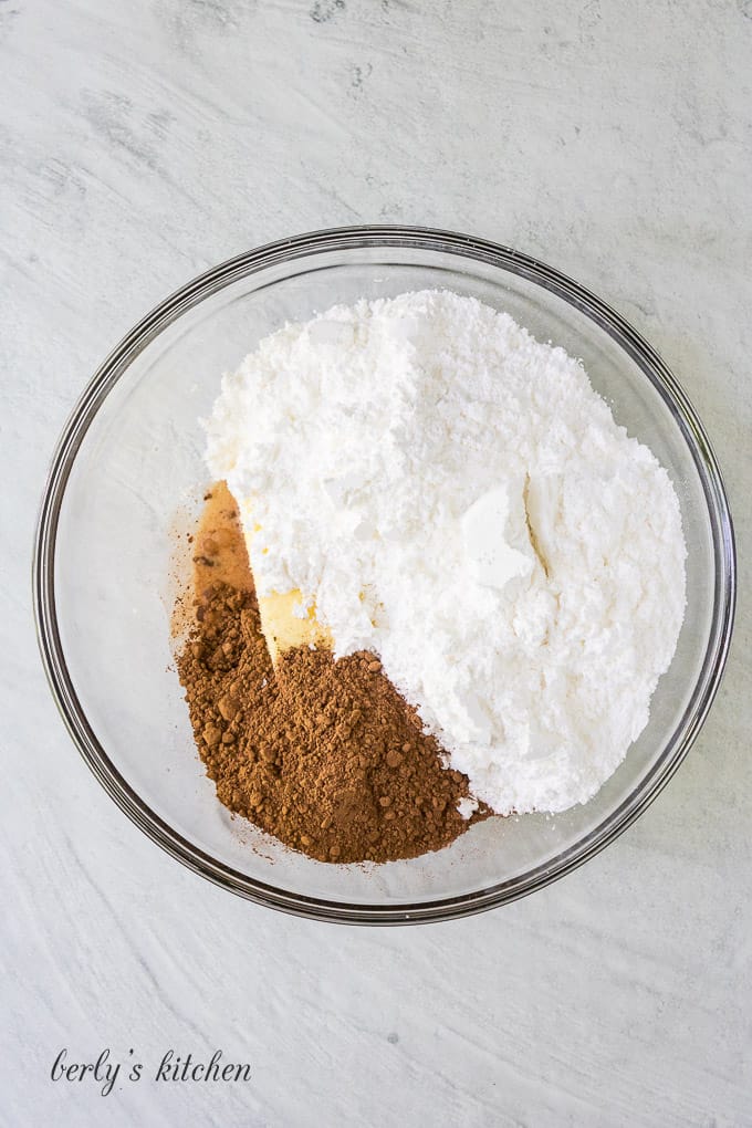 The sugar, butter, and other frosting ingredients in a bowl.