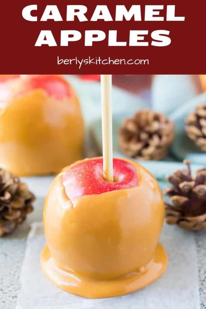 The caramel apple cooling on wax paper with Fall decor.