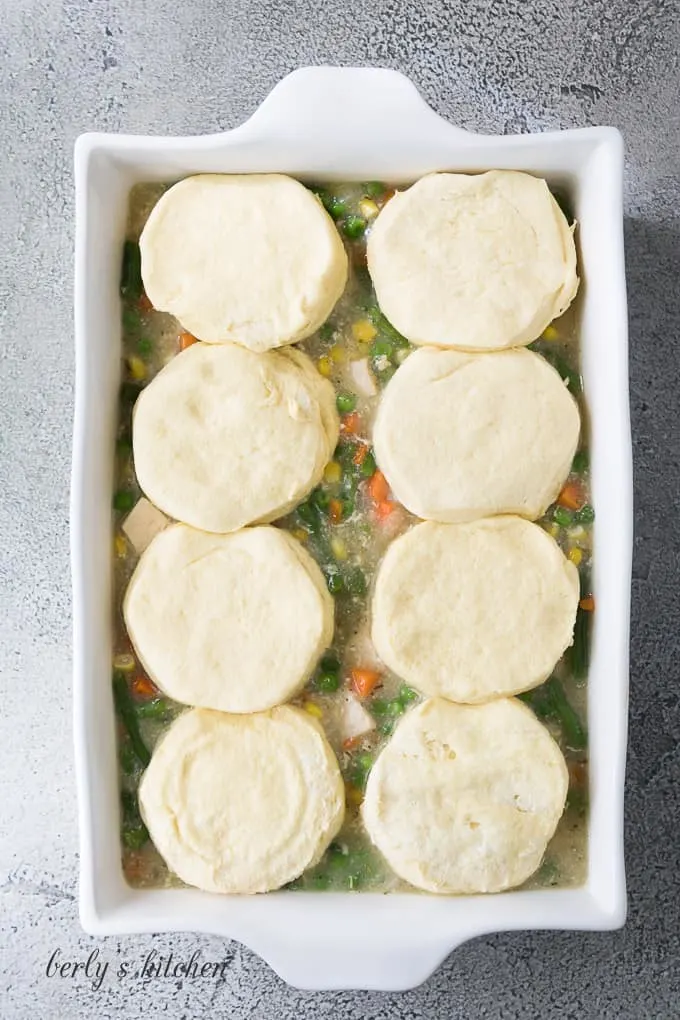 The filling transferred to a baking dish and topped with biscuits.