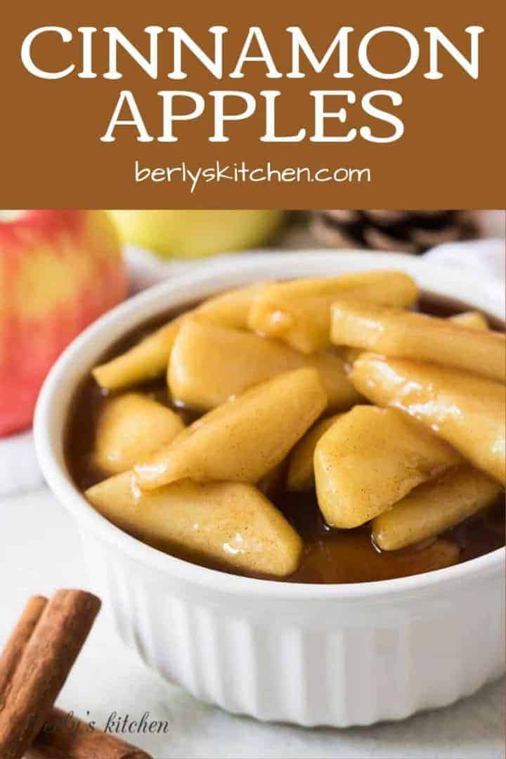 The cinnamon apples in a bowl surrounded by fall decorations.