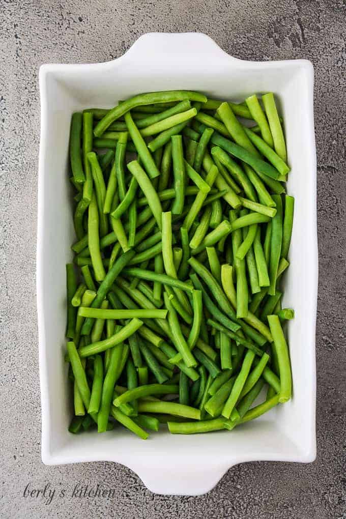 Washed and prepped green beans in a large baking dish.