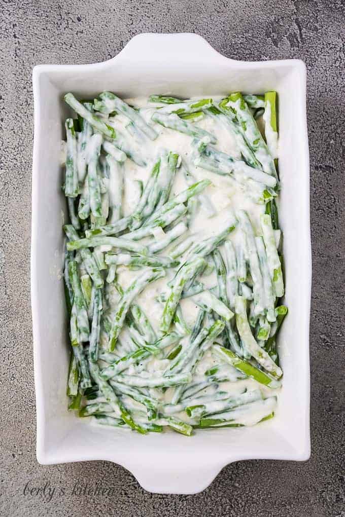 The sauce has been poured over the vegetables in the baking dish.