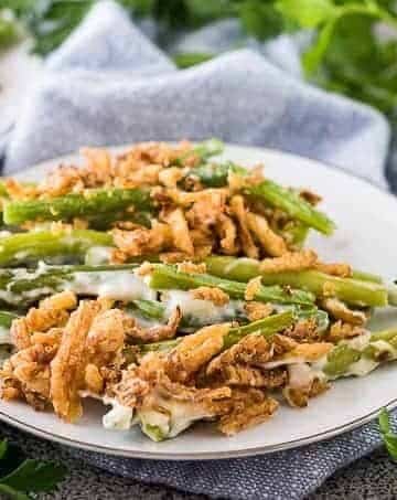A serving of green bean casserole on a decorative plate.