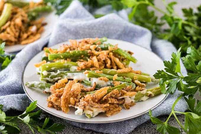 A serving of green bean casserole on a decorative plate.