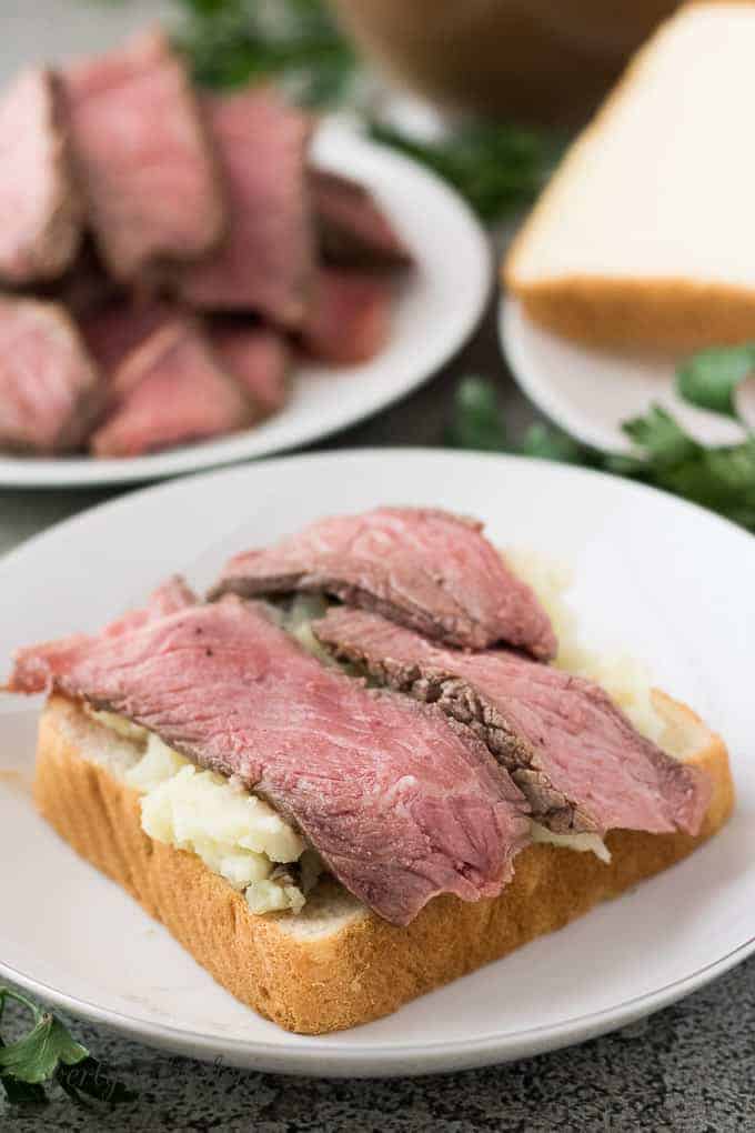 Sliced leftover pot roast laid on top of the potatoes.